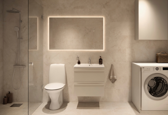 Modernt badrum med toalett, handfat, dusch, tvättmaskin och en stor bakgrundsbelyst spegel.