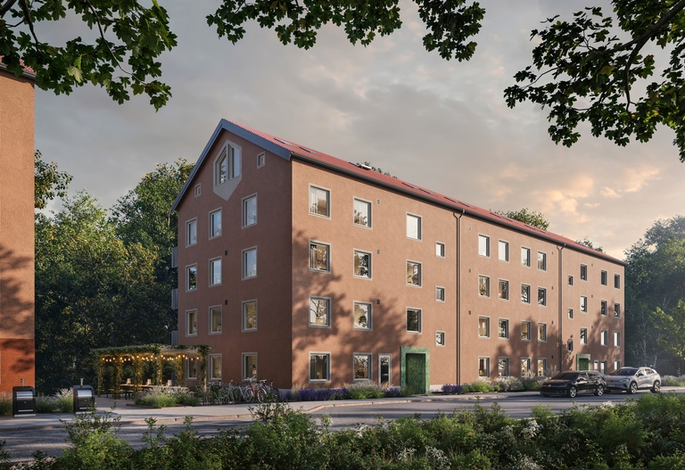 Podium. Flerfamiljshusmed fyra våningar och rött tak, omgivet av träd och en gata framför.