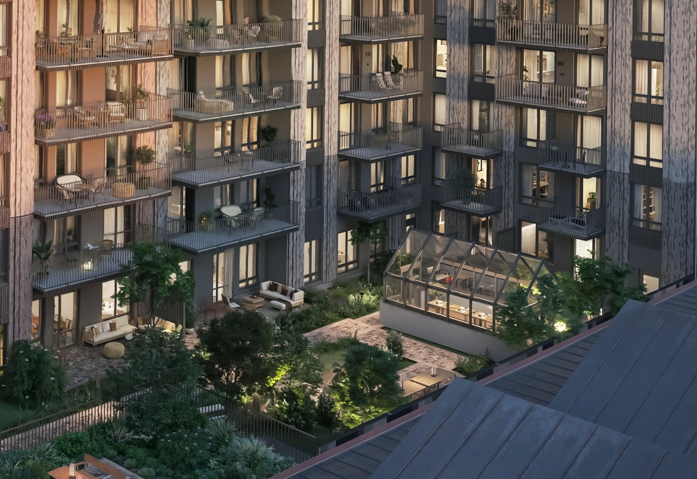 House of Nelly. Modernt flerbostadshus med balkonger som vetter mot en anlagd innergård med växthus i glas.